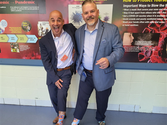 Superintendent-Director Ernest F. Houle and visiting superintendent with matching socks