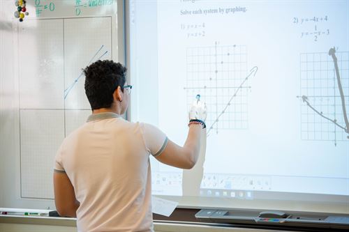 A student at the board working on a problem