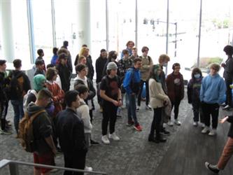 Students standing around in a large dispersed group 