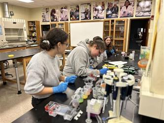Students working with tools at a lab table