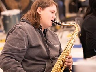 A student playing saxophone  