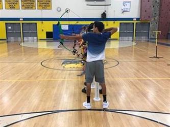 students practicing archery