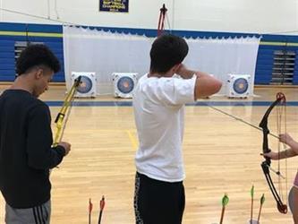 students practicing archery