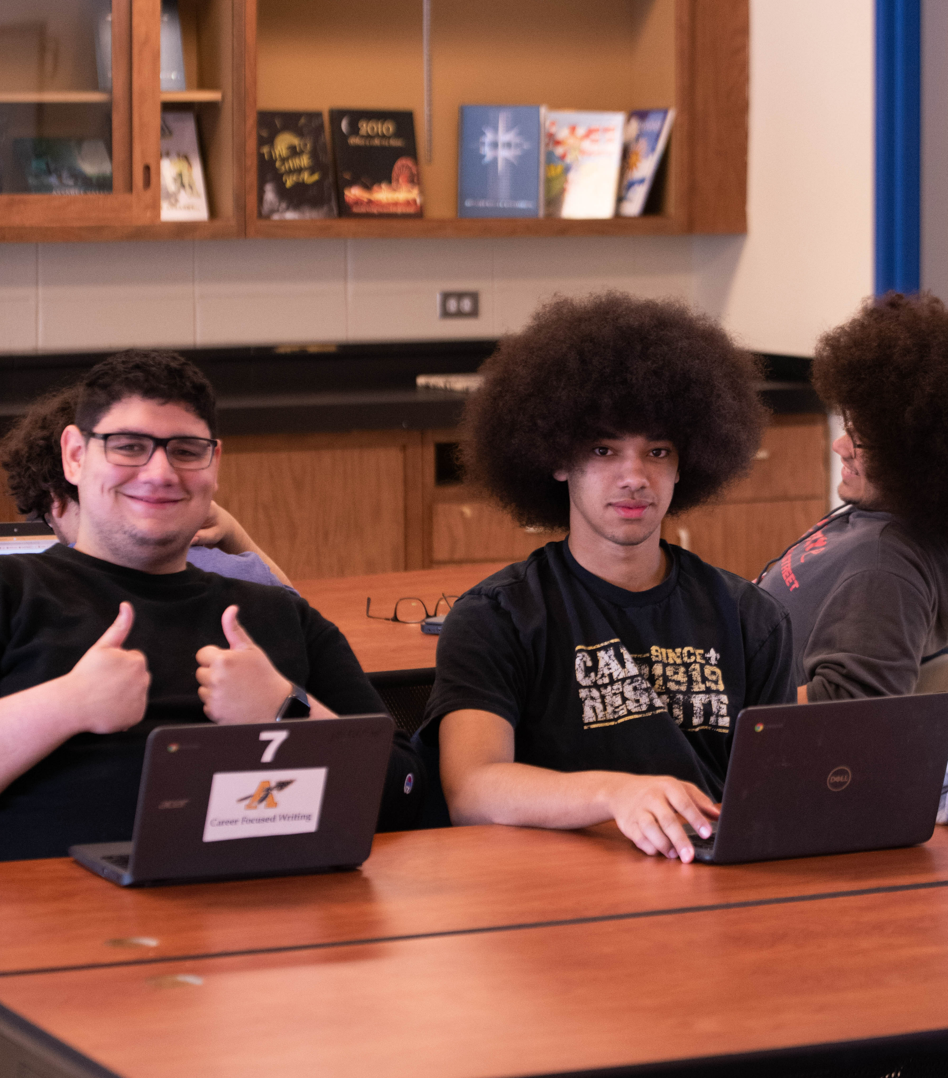 two students with chromebooks at a desk